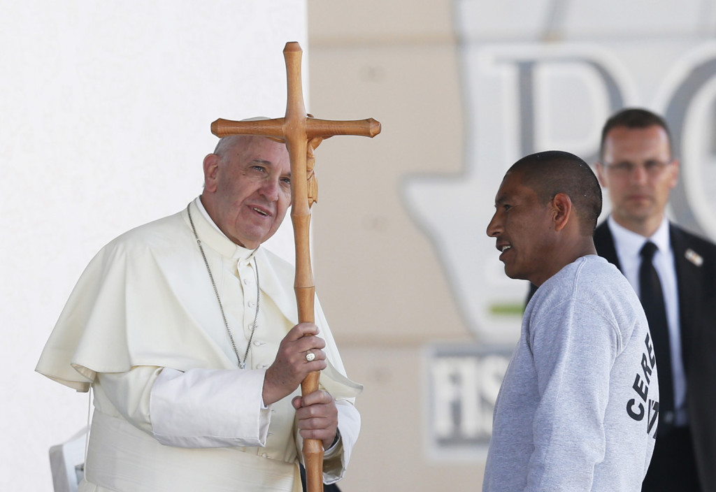 Pope Francis accepts a crucifix from a prisoner as he visits Cereso prison in Ciudad Juarez, Mexico, Feb. 17. (CNS photo/Paul Haring) See POPE-MEXICO-PRISON Feb. 17, 2016.