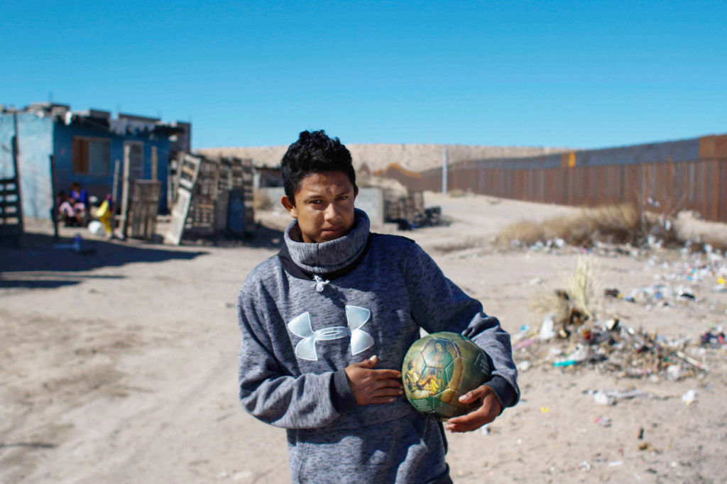 A young man holds a soccer ball with an image of Our Lady of Guadalupe Jan. 26 in Ciudad Juarez, Mexico, near the U.S.-Mexico border fence.In a joint statement, Catholic bishops whose dioceses are along the U.S.-Mexico border called for respecting people's dignity regardless of "migration condition." (CNS photo/Alejandro Bringas, EPA) See BORDER-BISHOPS-IMMIGRATION Feb. 16, 2017.