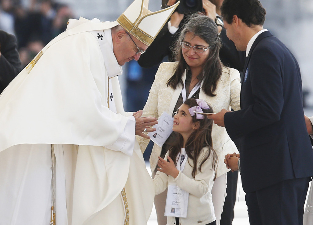 Pope Francis accepts offertory gifts during the canonization Mass of Sts. Francisco and Jacinta Marto, two of the three Fatima seers, at the Shrine of Our Lady of Fatima in Portugal May 13. The Mass marked the 100th anniversary of the Fatima Marian apparitions, which began on May 13, 1917. (CNS photo/Paul Haring) See POPE-FATIMA-CANONIZATION May 13, 2017.